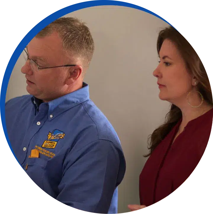 Technician speaking with a homeowner about needed services.