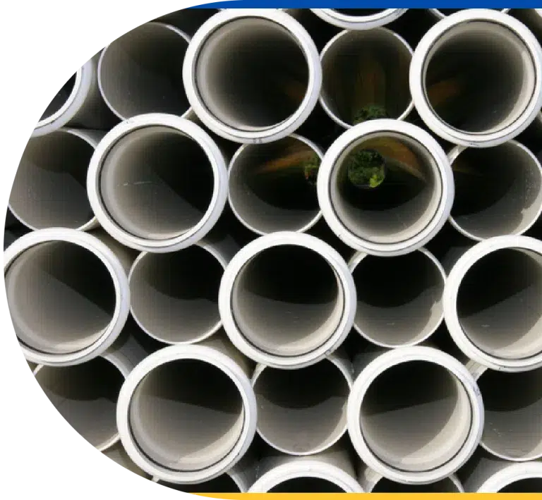 A view through clean un-installed sewer line pipes, stacked together.